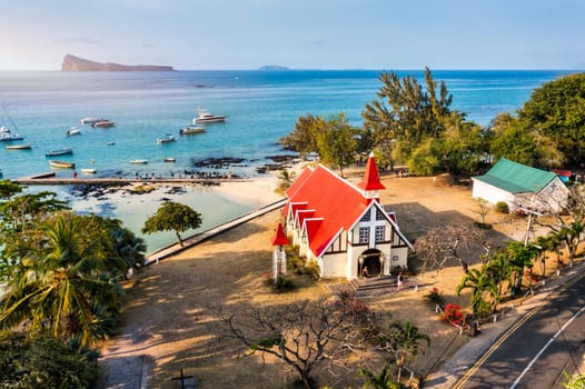 Red church at Cap Malheureux village, Mauritius Island. Notre Dame de Auxiliatrice, rural church with red roof in Cap Malheureux tropical village on Mauritius island, Indian Ocean.