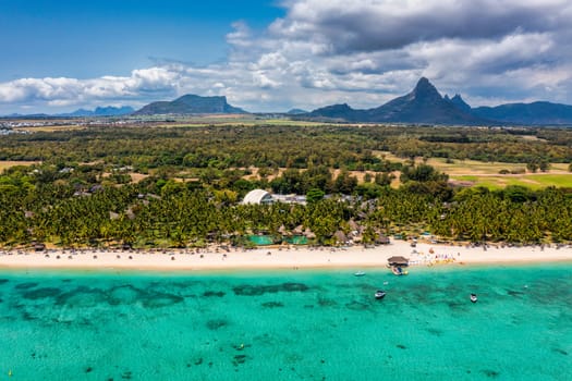 Beach of Flic en Flac with beautiful peaks in the background, Mauritius. Beautiful Mauritius Island with gorgeous beach Flic en Flac, aerial view from drone. Flic en Flac Beach, Mauritius Island.