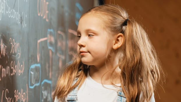 Caucasian girl looking at blackboard with coding prompt written. Attractive student planing a project by using coding and programing system in STEM technology innovative class. Closeup. Erudition.