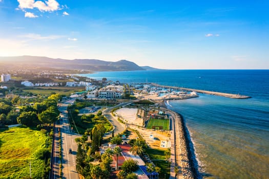 View of Latchi port, Akamas peninsula, Polis Chrysochous, Paphos, Cyprus. The Latsi harbour with boats and yachts, fish restaurant, promenade, beach tourist area and mountains, Latchi, Cyprus.