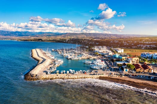 View of Latchi port, Akamas peninsula, Polis Chrysochous, Paphos, Cyprus. The Latsi harbour with boats and yachts, fish restaurant, promenade, beach tourist area and mountains, Latchi, Cyprus.