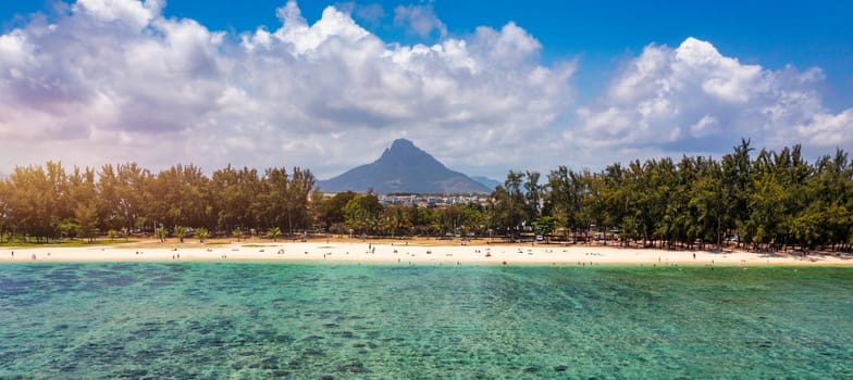 Beach of Flic en Flac with beautiful peaks in the background, Mauritius. Beautiful Mauritius Island with gorgeous beach Flic en Flac, aerial view from drone. Flic en Flac Beach, Mauritius Island.