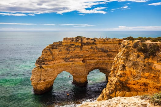 Praia da Marinha, beautiful beach Marinha in Algarve, Portugal. Navy Beach (Praia da Marinha) with flying seagulls over the beach, located on the Atlantic coast in Lagoa Municipality, Algarve.