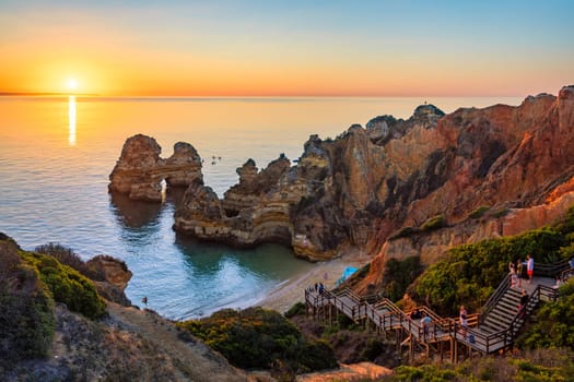 Camilo beach (Praia do Camilo) in Lagos, Algarve, Portugal. Wooden footbridge to the beach Praia do Camilo, Portugal. Picturesque view of Praia do Camilo beach in Lagos, Algarve region, Portugal.