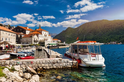 View of the historic town of Perast at famous Bay of Kotor on a beautiful sunny day with blue sky and clouds in summer, Montenegro. Historic city of Perast at Bay of Kotor in summer, Montenegro.