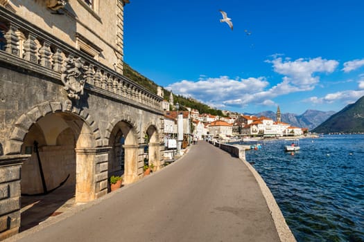 View of the historic town of Perast at famous Bay of Kotor on a beautiful sunny day with blue sky and clouds in summer, Montenegro. Historic city of Perast at Bay of Kotor in summer, Montenegro.