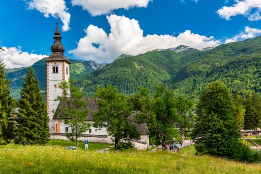 Aerial view of Bohinj lake in Julian Alps. Popular touristic destination in Slovenia. Bohinj Lake, Church of St John the Baptist. Triglav National Park, Julian Alps, Slovenia. 