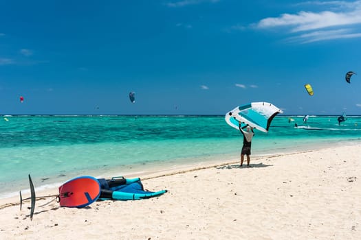 Kite surfers in the waters of Indian Ocean, Mauritius. Kite surfing in the clear waters of the Indian Ocean in Le Morne beach, Mauritius. Best Kite surfing experience at Mauritius island.