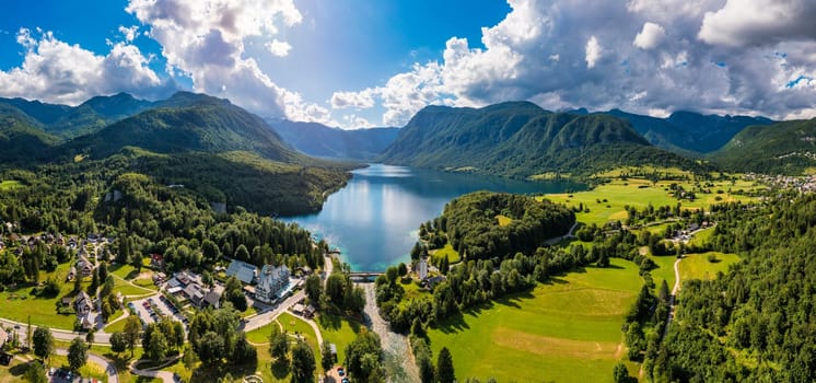 Aerial view of Bohinj lake in Julian Alps. Popular touristic destination in Slovenia. Bohinj Lake, Church of St John the Baptist. Triglav National Park, Julian Alps, Slovenia. 