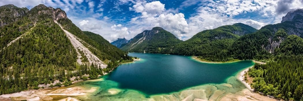 View to Julian Alps mountains above Predil lake in Italy with small lake. Predil Lake, Friuli Italy / (Lago del Predil), beautiful alpine lake in north Italy near the Slovenian border, Italy.