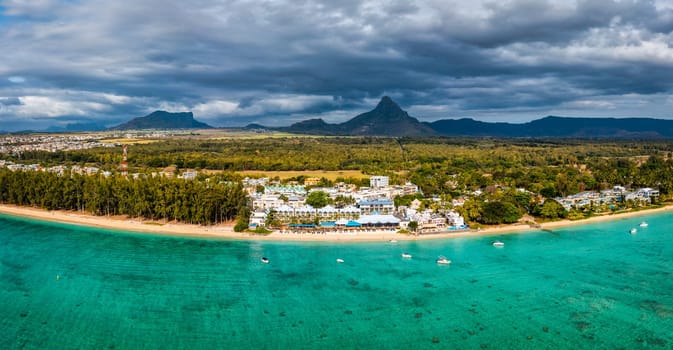 Beautiful Mauritius Island with gorgeous beach Flic en Flac, aerial view from drone. Mauritius, Black River, Flic-en-Flac view of oceanside village beach and luxurious hotel in summer.