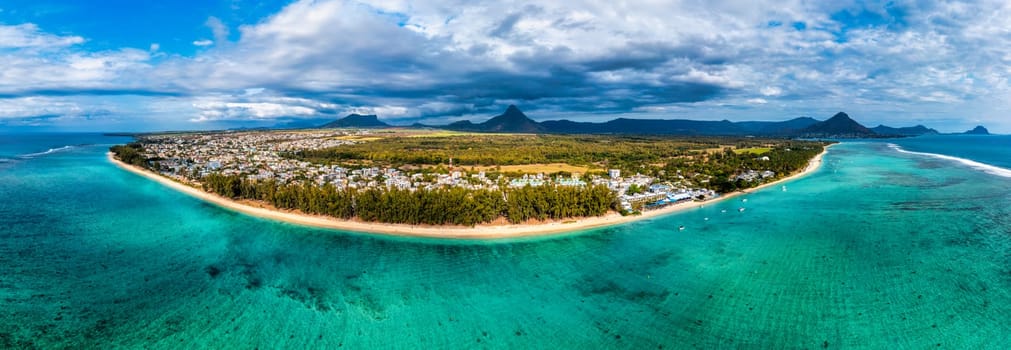 Beach of Flic en Flac with beautiful peaks in the background, Mauritius. Beautiful Mauritius Island with gorgeous beach Flic en Flac, aerial view from drone. Flic en Flac Beach, Mauritius Island.