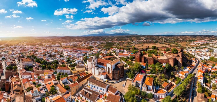 View of Silves town buildings with famous castle and cathedral, Algarve region, Portugal. Walls of medieval castle in Silves town, Algarve region, Portugal. 