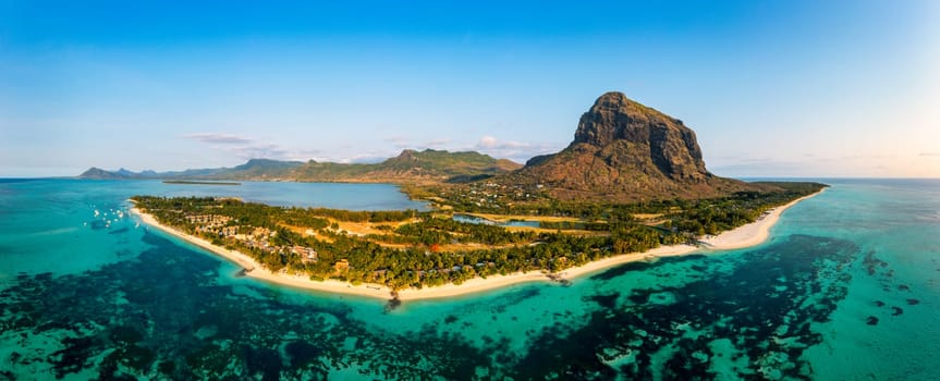 Aerial view of Le morne Brabant in Mauriutius. Tropical crystal ocean with Le Morne mountain and luxury beach in Mauritius. Le Morne beach with palm trees, white sand and luxury resorts, Mauritius.