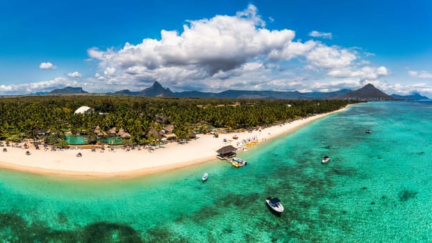 Beautiful Mauritius Island with gorgeous beach Flic en Flac, aerial view from drone. Mauritius, Black River, Flic-en-Flac view of oceanside village beach and luxurious hotel in summer.