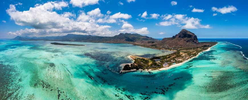 Aerial view of Le morne Brabant in Mauriutius. Tropical crystal ocean with Le Morne mountain and luxury beach in Mauritius. Le Morne beach with palm trees, white sand and luxury resorts, Mauritius.