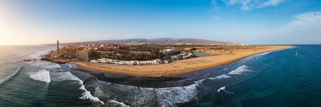 Lighthouse of Maspalomas at Gran Canaria Island known as Faro de Maspalomas at sunset. Seascape with lighthouse and Maspalomas beach. Gran Canaria, Canary Islands, Spain