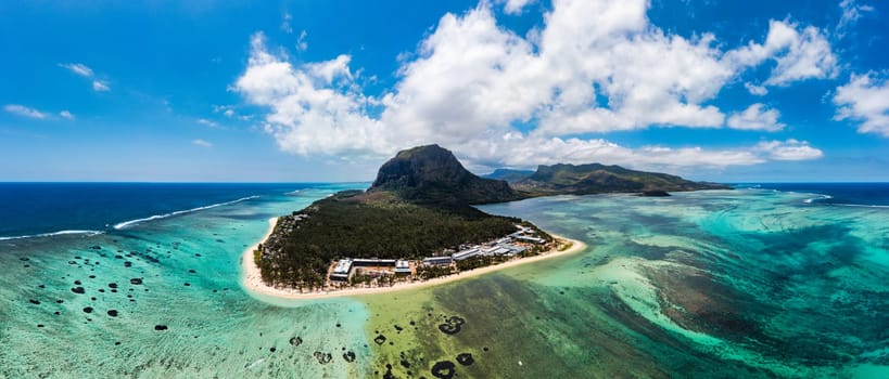 Aerial view of Le morne Brabant in Mauriutius. Tropical crystal ocean with Le Morne mountain and luxury beach in Mauritius. Le Morne beach with palm trees, white sand and luxury resorts, Mauritius.
