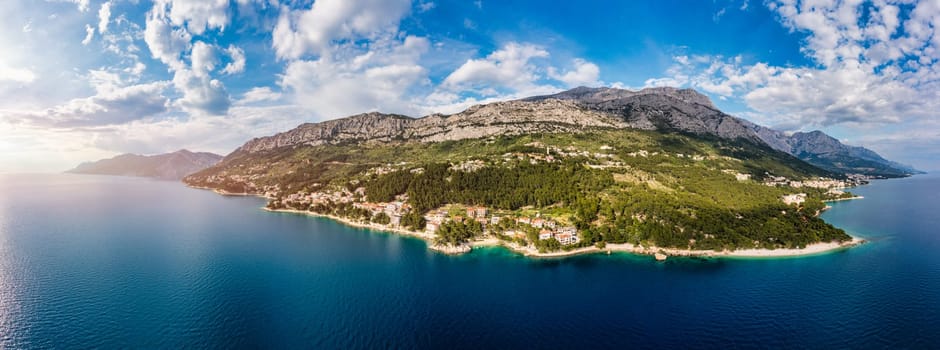 Beautiful Brela on Makarska riviera, Croatia. Adriatic Sea with amazing turquoise clean water and white sand. Aerial view of Brela beach and waterfront on Makarska riviera, Dalmatia region of Croatia.