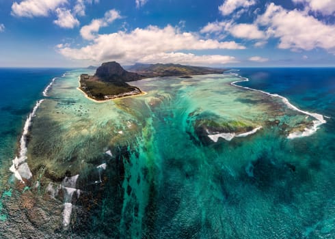 Aerial view of Mauritius island panorama and famous Le Morne Brabant mountain, beautiful blue lagoon and underwater waterfall. Le Morne Brabant peninsula and Underwater Waterfall, Mauritius.