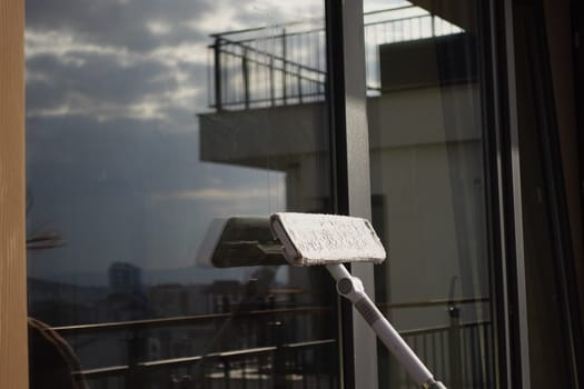 Rubber squeegee cleans a soaped window