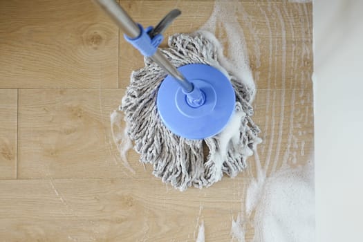 cleaning tiles floor with mop .