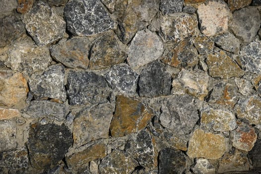 Granite stones of different shapes and colors. Wall cladding. 3