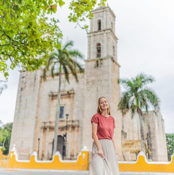 Woman tourist explores the vibrant streets of Valladolid, Mexico, immersing herself in the rich culture and colorful architecture of this charming colonial town.