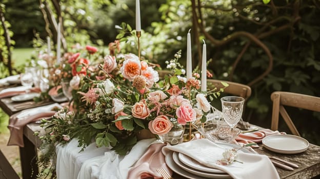 Table setting with rose flowers and candles for an event party or wedding reception in the summer garden.