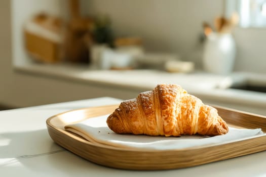 A croissant is sitting on a napkin on a wooden tray. Generative AI
