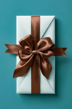 A brown ribbon is tied around a white gift box. Generative AI