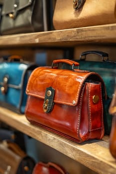 A brown leather purse sits on a shelf next to other purses. The purse is made of leather and has a gold clasp. Generative AI