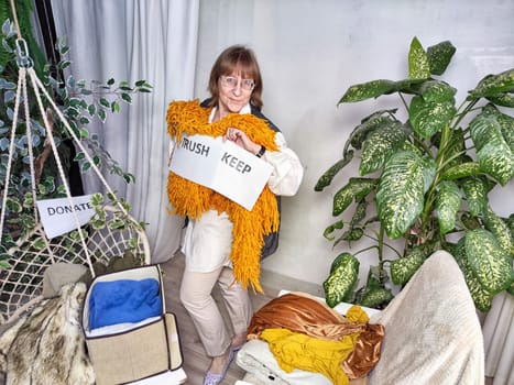 Middle-Aged Woman Sorting Belongings With KonMari Method. Mature woman categorizes items into keep and discard piles