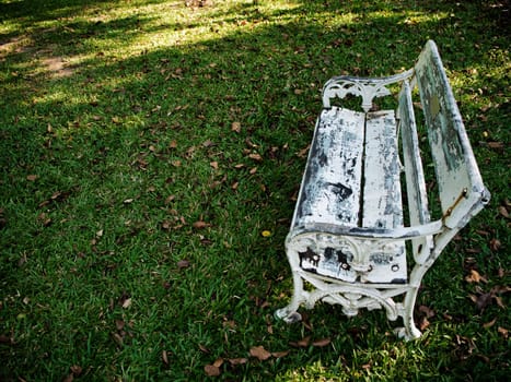 Old white field chairs on the lawn