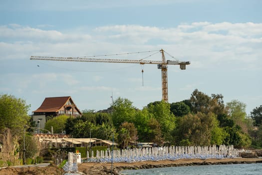 Construction crane working on large construction site