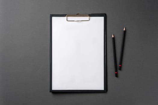 Blank A4 paper attached to the clipboard and pencil on it