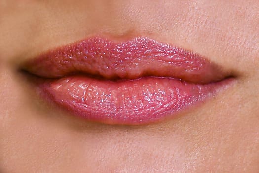 Big beautiful lips painted with scarlet lipstick close-up