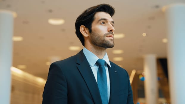 Portrait imaged of professional business man looking around at mall. Executive manager standing at mall while smiling with confident. Finding a job, decide to invest money, planing idea. Exultant.