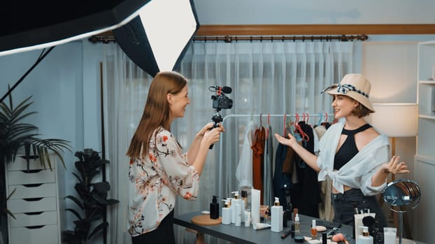 Two influencer partner shoot live streaming vlog video review makeup prim social media or blog. Happy young girl with cosmetics studio lighting for marketing recording session broadcasting online.