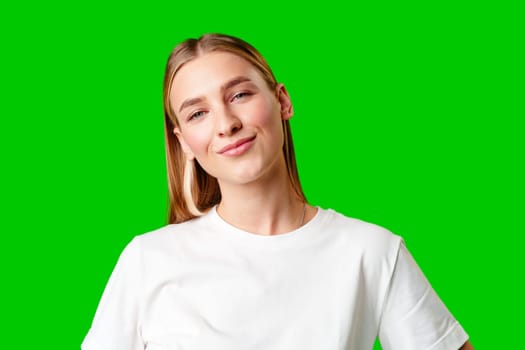 Young Woman in White Shirt Posing for Picture against green background in studio