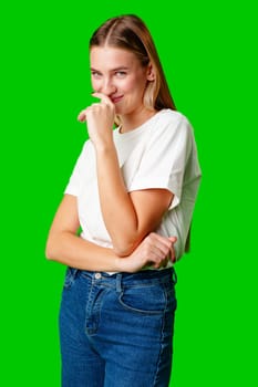 Young Woman in White Shirt Posing for Picture against green background in studio