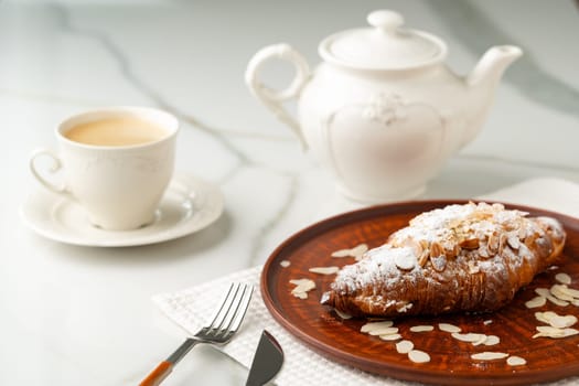 Almond Croissant on clay plate close up photo