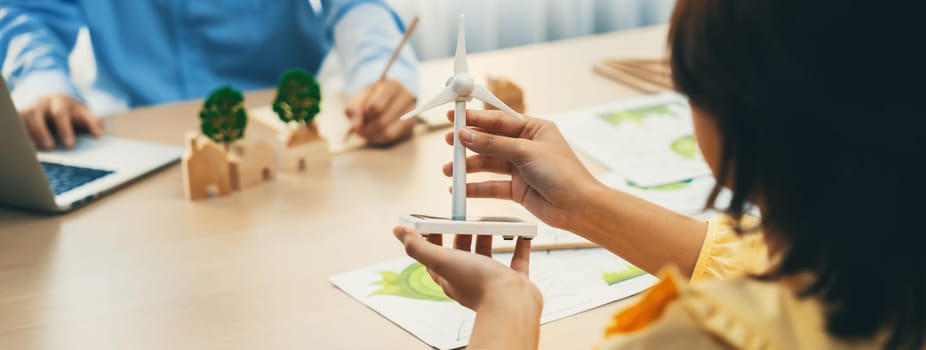 Businesswoman interested in investing in renewable energy at meeting table with environmental document scatter around. Business team discussion about green business project. Closeup. Delineation.