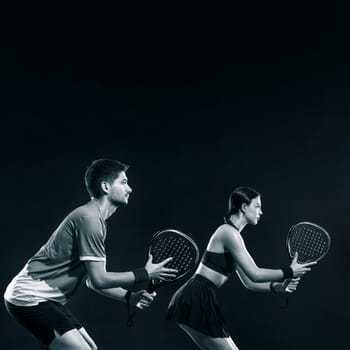 Padel tennis players with racket. Man and woman athletes with racket on court. Sport concept. Download a high quality photo for the design of a sports app or betting site