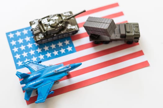 USA flag image photo with a combat plane, khaki green tank and military car standing on american flag. High quality photo