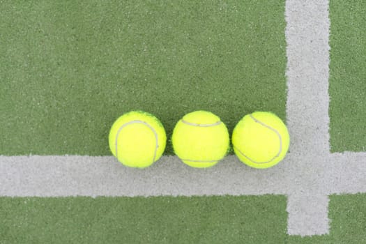 close up of a padel and tennis court with artificial grass and balls. High quality photo