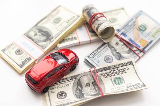 Small decorative car model, a lot of cash dollars of USA, credit for car concept. High quality photo