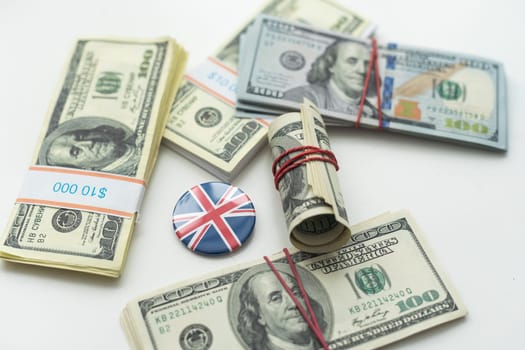 Cash money close up, top view. A bundle of 100 dollar bills lies on a pile of banknotes of various countries (dollars, euros, rubles). High quality photo
