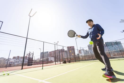 woman playing paddle tennis outdoors. High quality photo
