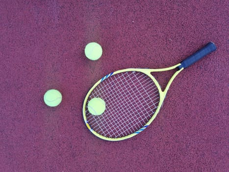 Tennis. Tennis ball and racket on a red background of tennis court with copy space. Sport and healthy lifestyle. The concept of outdoor game sports. . High quality photo